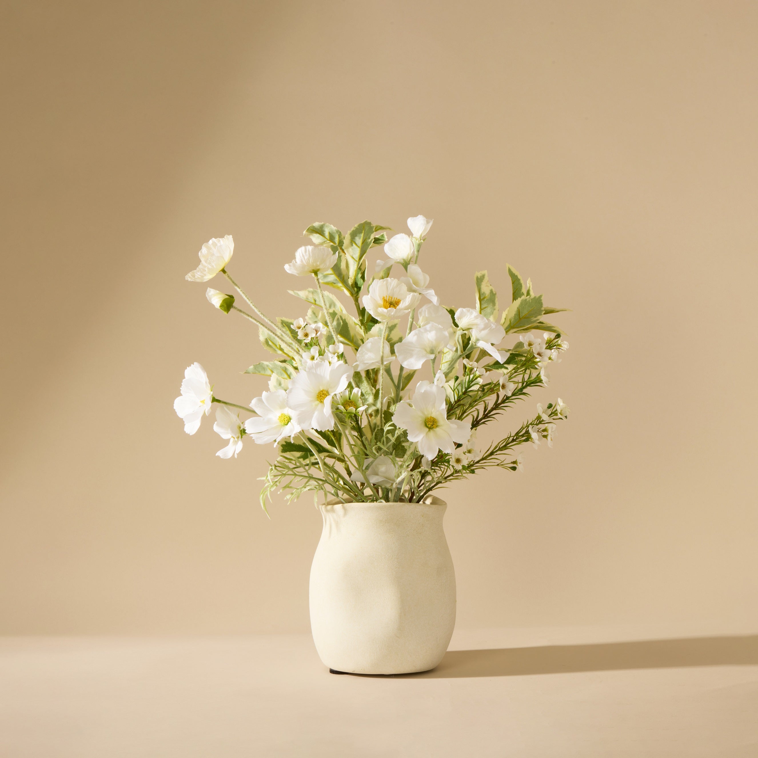White flowers in a vase on a beige background